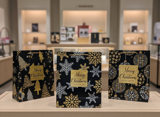 Set of four decorative Christmas bags with gold and white designs